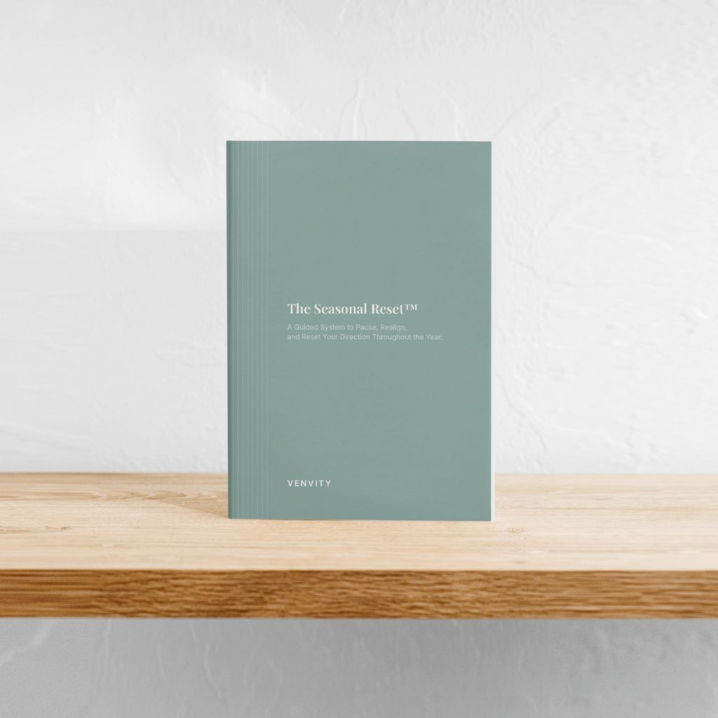The Seasonal Reset — sage green cover standing on a wooden shelf