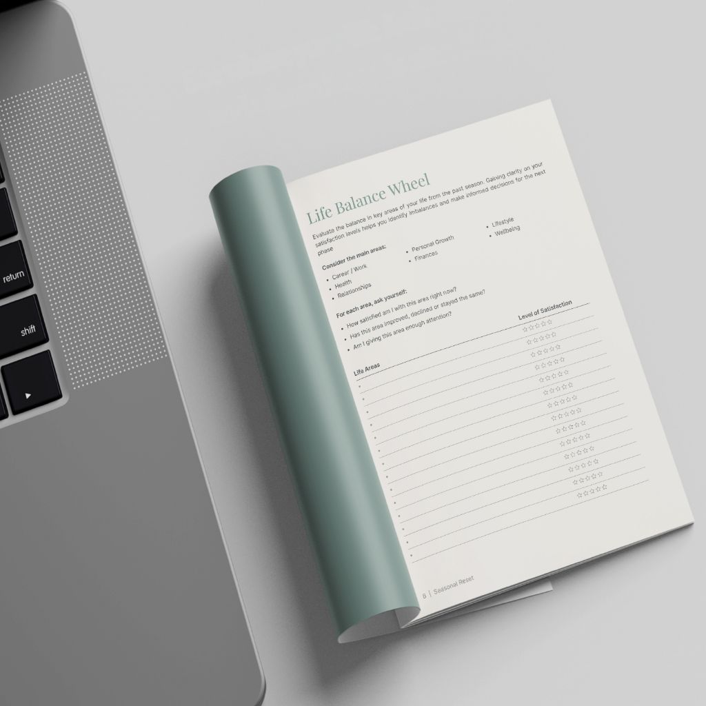 The Seasonal Reset — Life Balance Wheel page next to a laptop